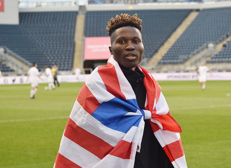 Daniel Yallah wrapped in a Liberian flag